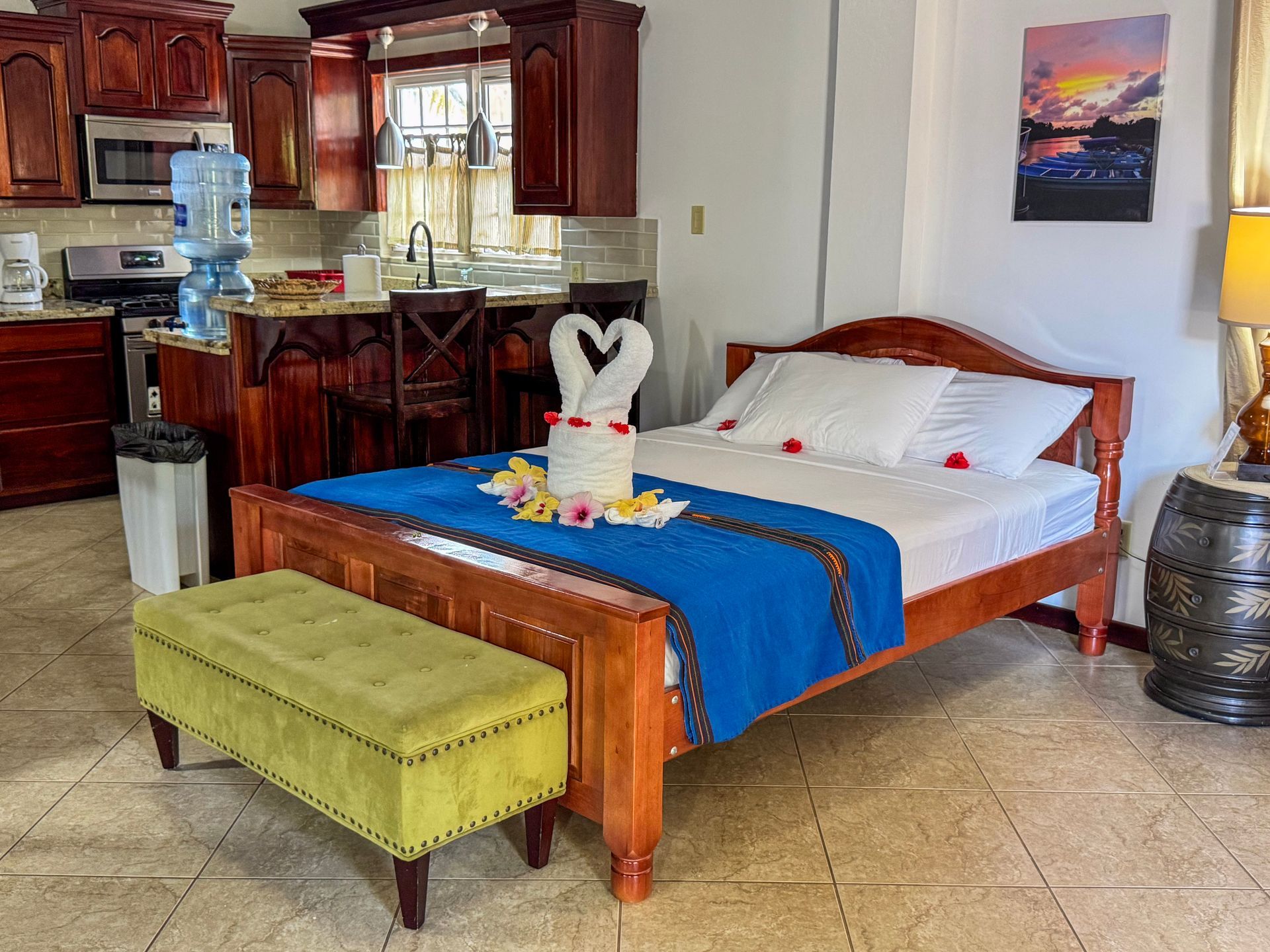 A bedroom with a bed and a bench in it