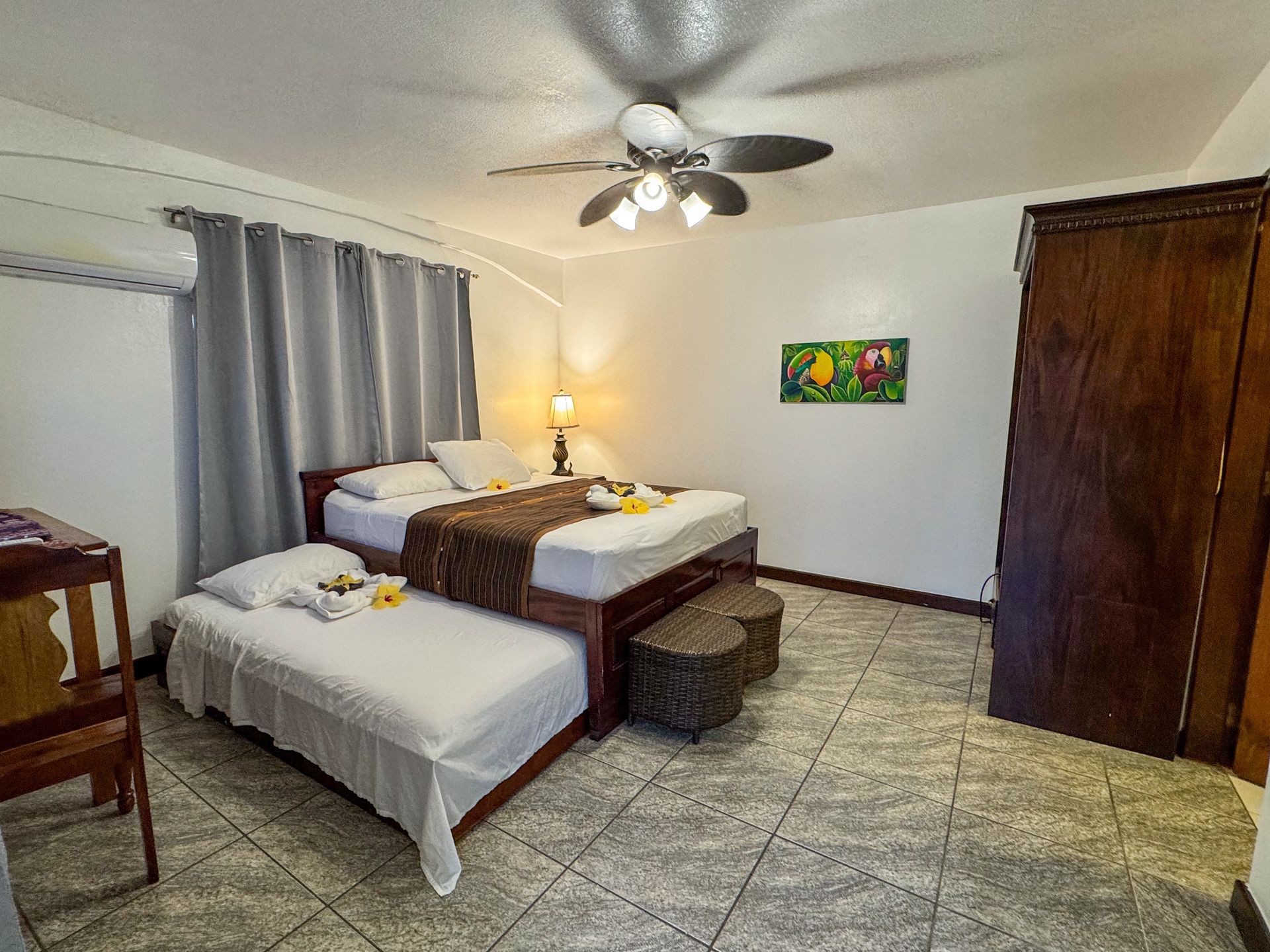 A hotel room with two beds and a ceiling fan, best room for couples at Caribbean Shores B&B, Hopkins Village