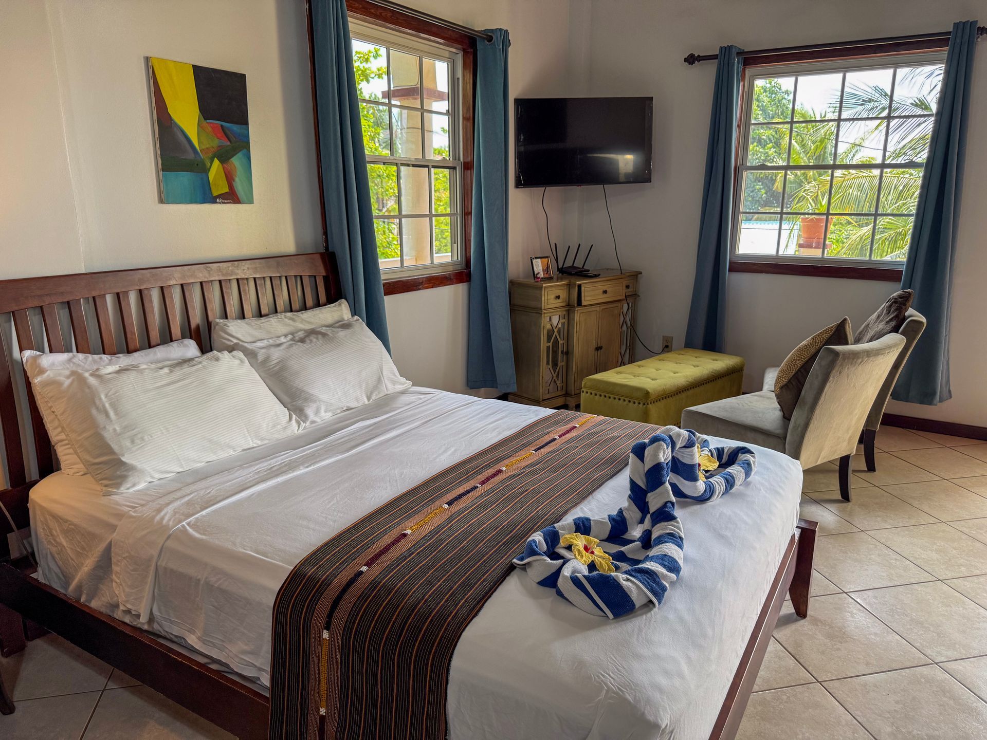 A bedroom with a bed , chairs , a television, best rooms in Hopkins Village 