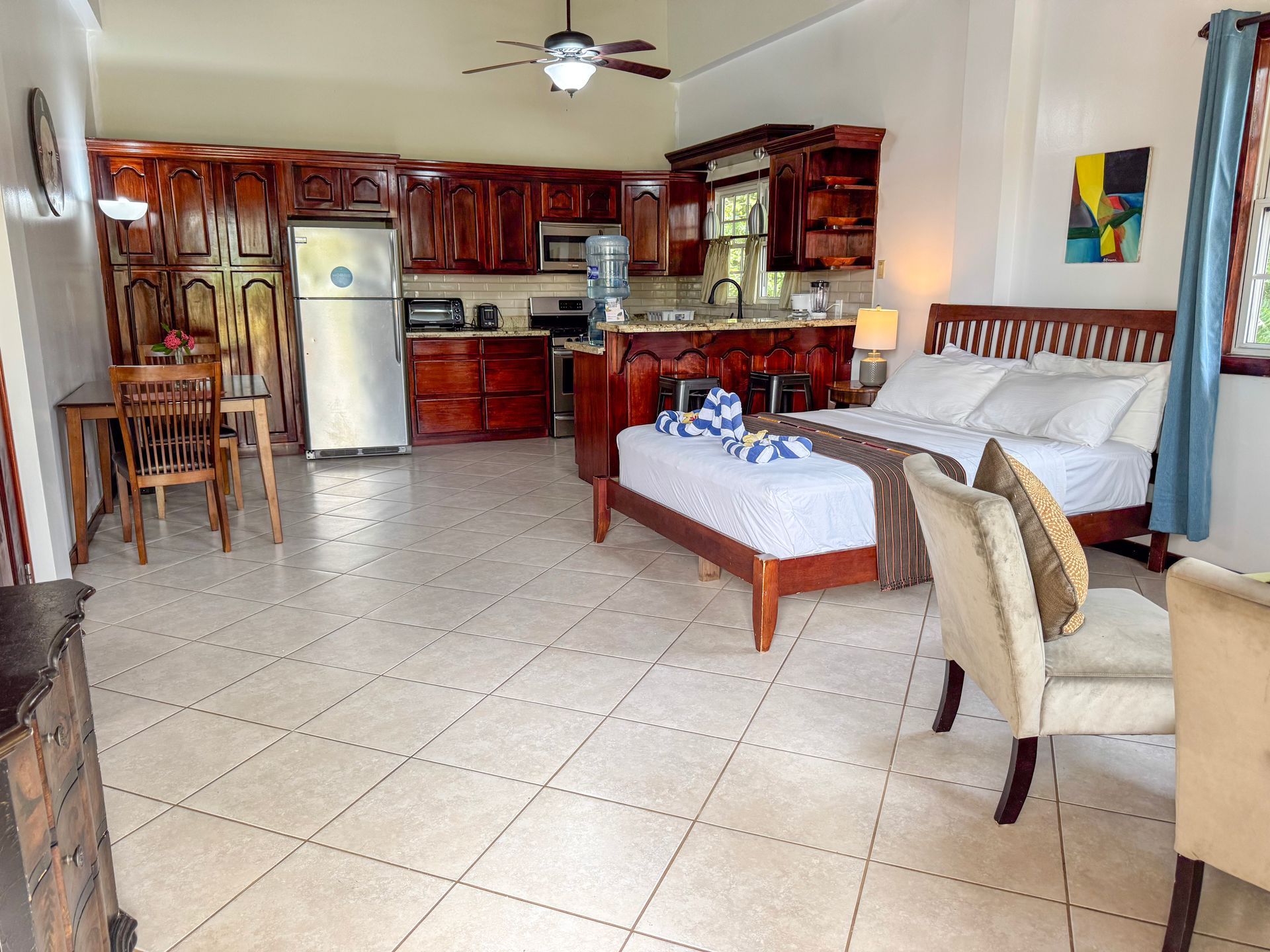 A Studio apartment with a queen size bed and a kitchen in Hopkins Village