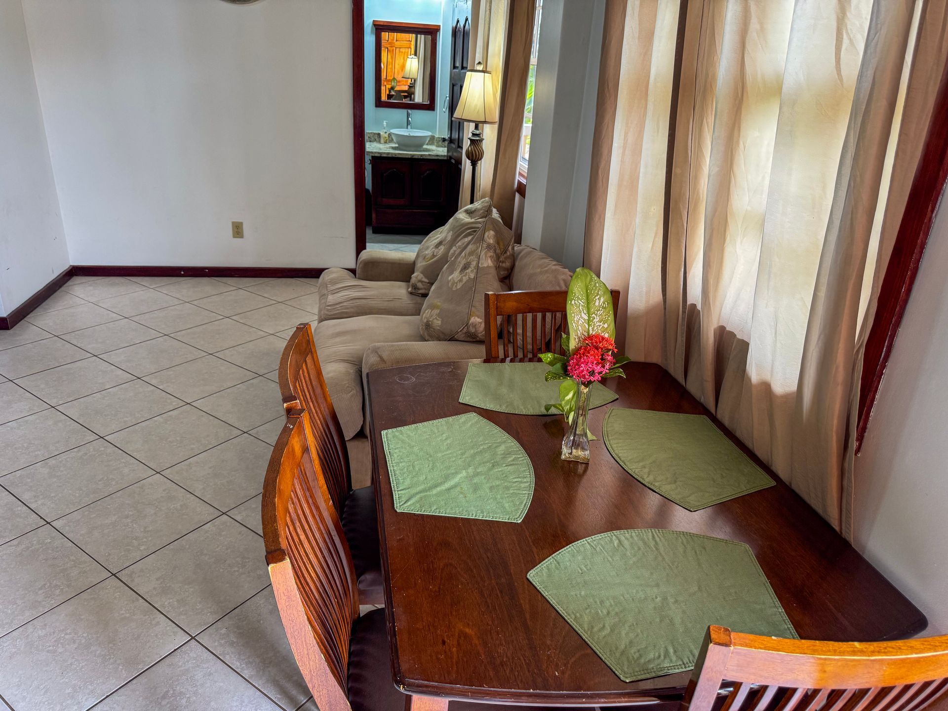 A living room with a table and chairs and a couch
