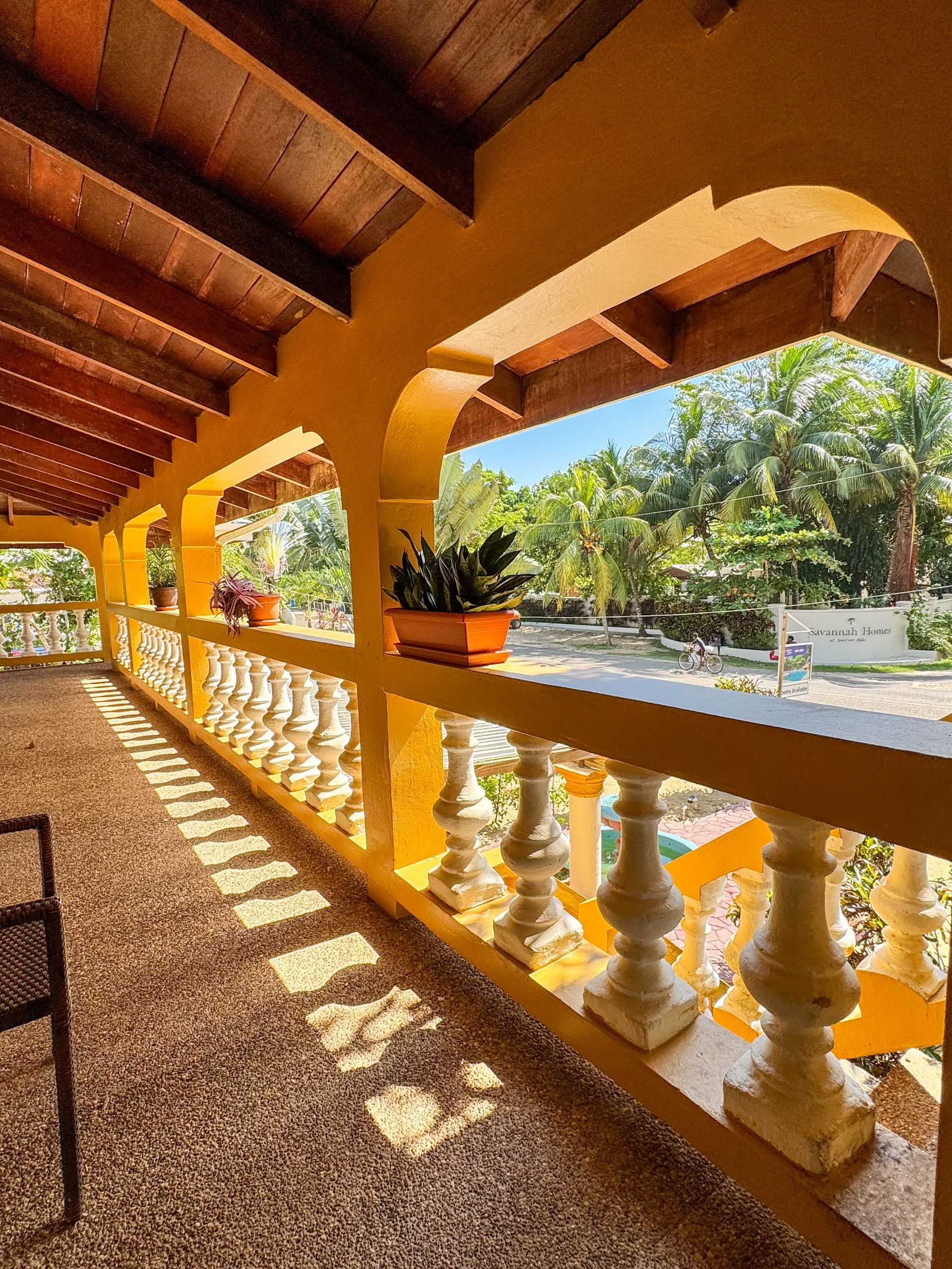 A balcony with a view of a lush green forest, the view at Caribbean Shores Bed and Breakfast, Hopkins Belize