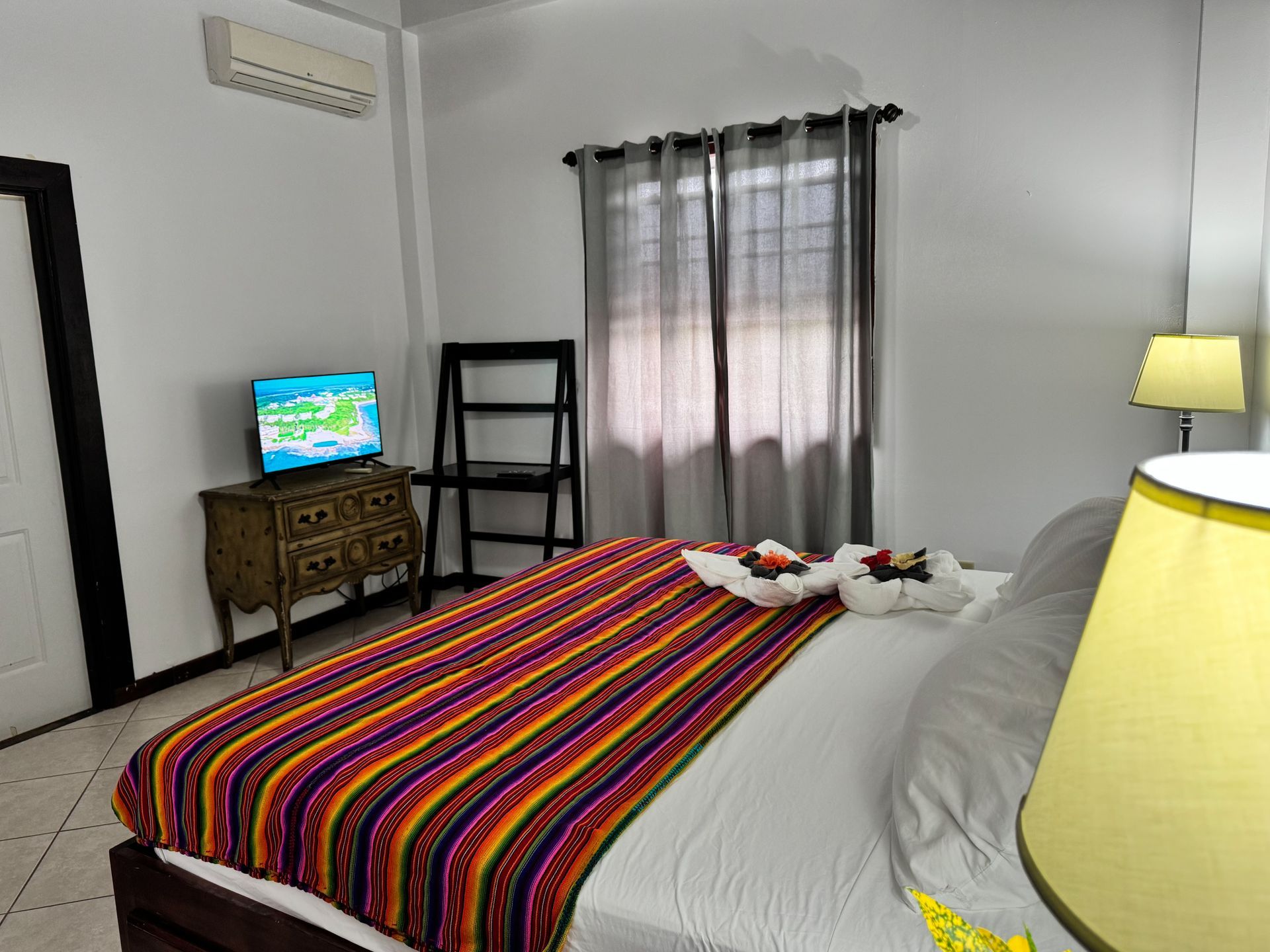 A bedroom with a bed , chair , lamp and television. Hopkins Village bed and breakfast