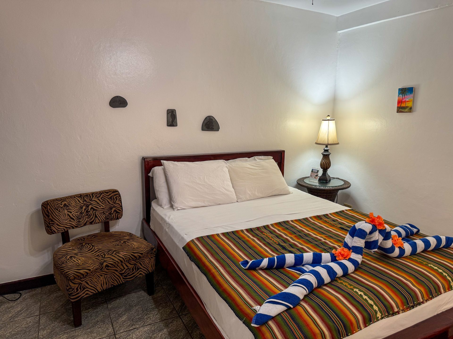 A hotel room with a bed , chair and lamp, short term rental in Hopkins Village