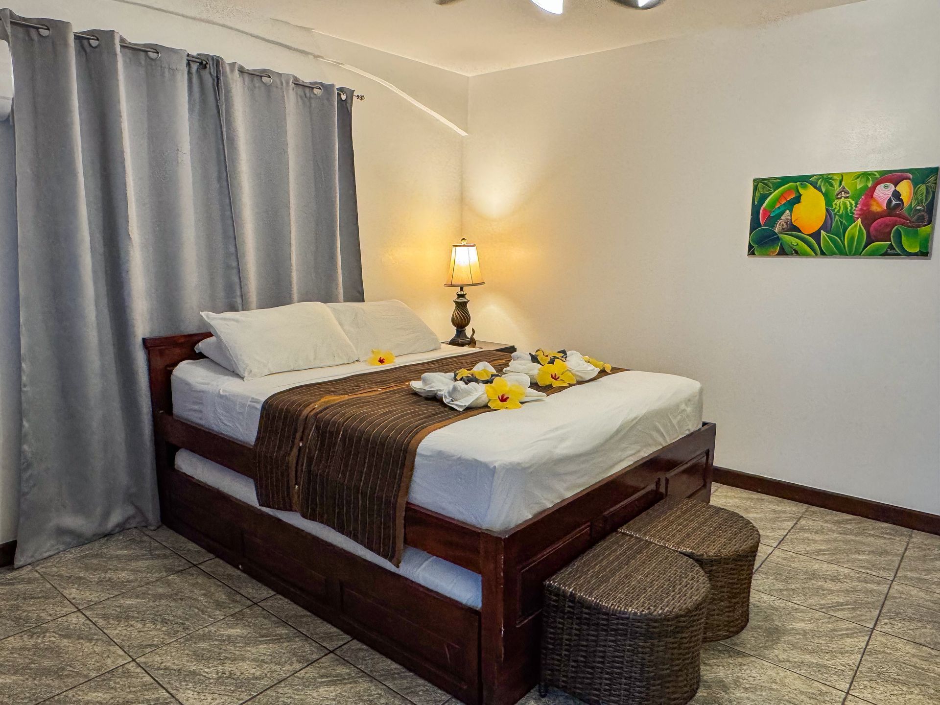 A bedroom with a king size bed and a painting on the wall, affordable home in Hopkins Village