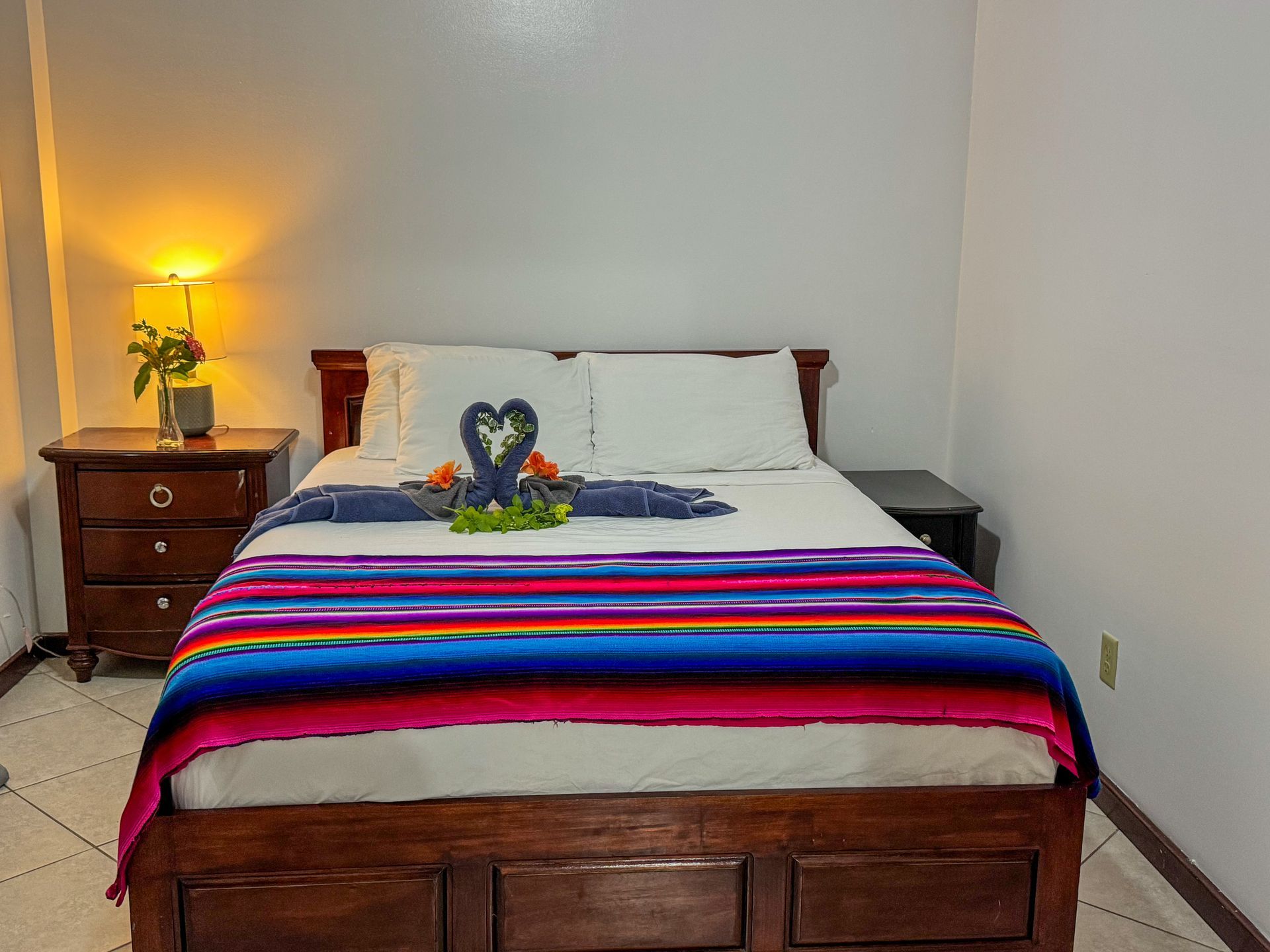 A bedroom with a bed , nightstand and lamp, studio apartment near the beach Hopkins