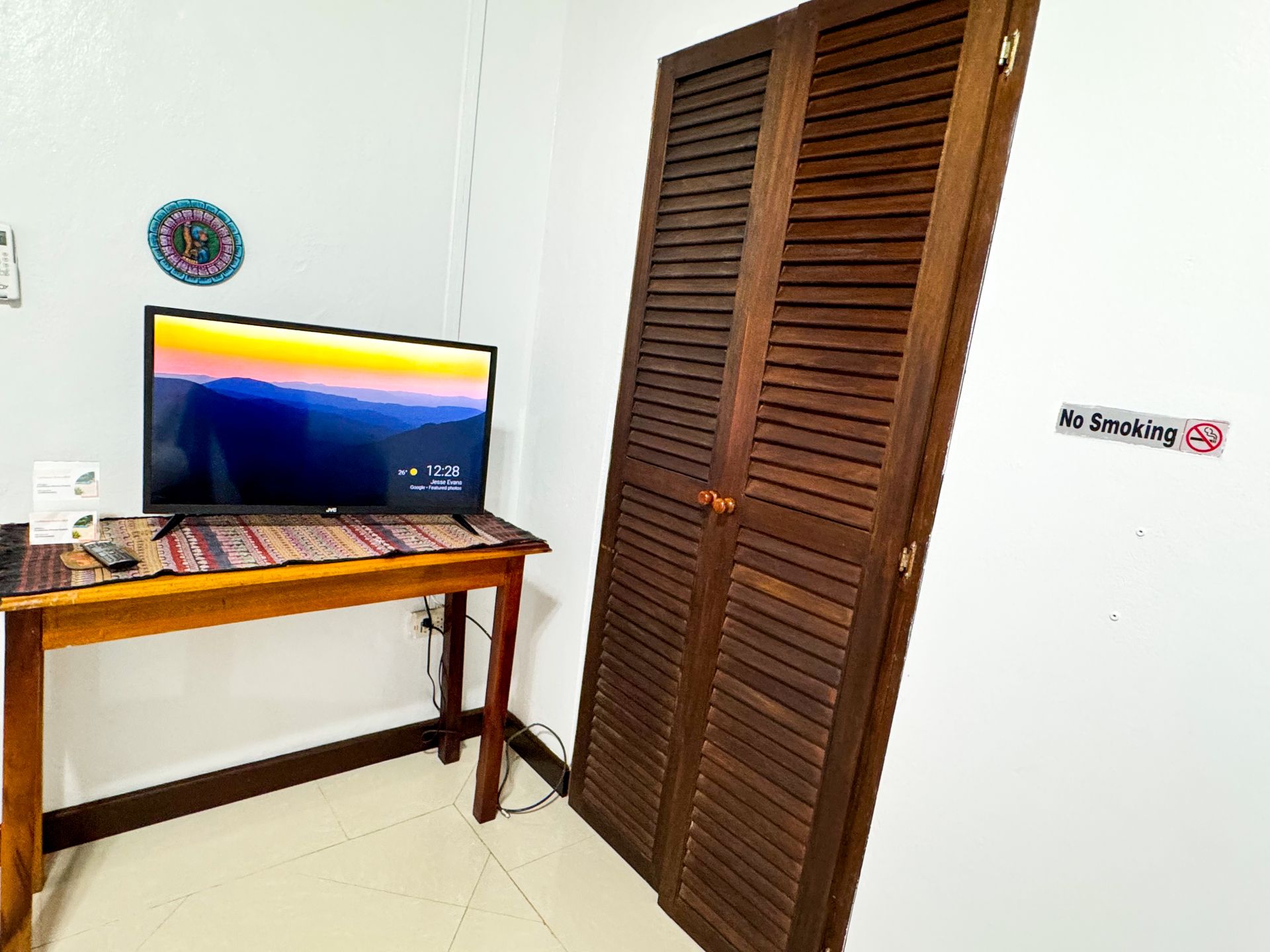 A room with a wooden table and a flat screen tv, Hopkins , belize