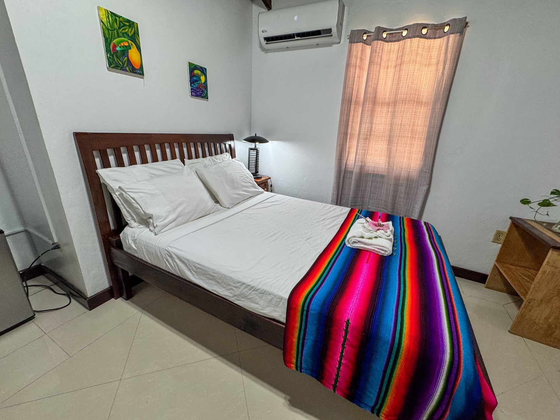 A bedroom with a bed and a colorful blanket on it , best places to stay in Hopkins Village