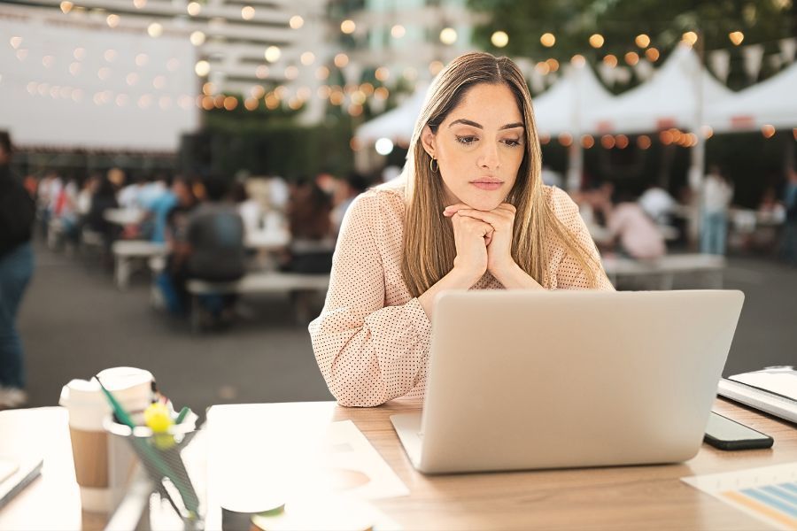 woman looking at laptop looking for temporary staff agency