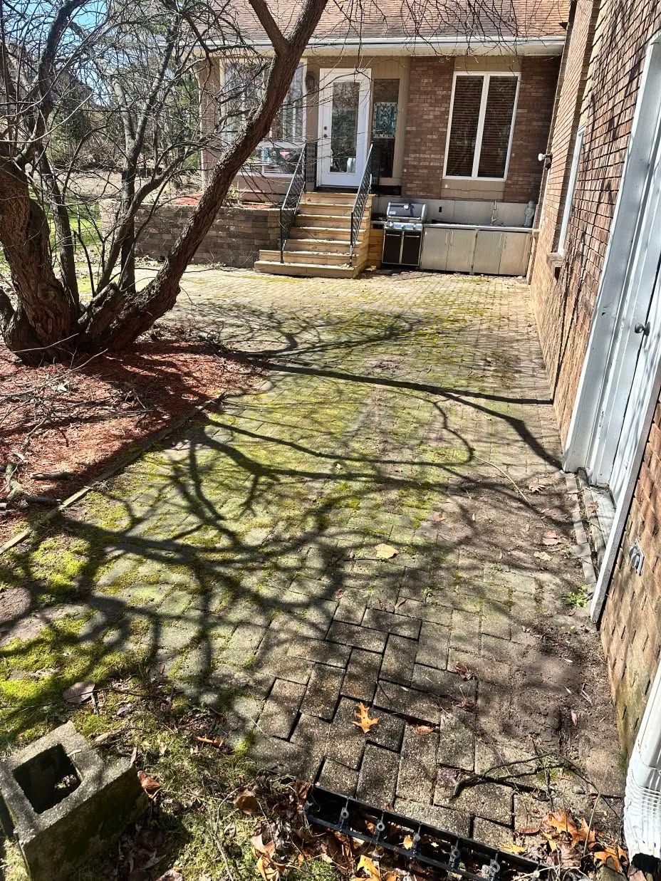 A brick house with a patio in front of it.