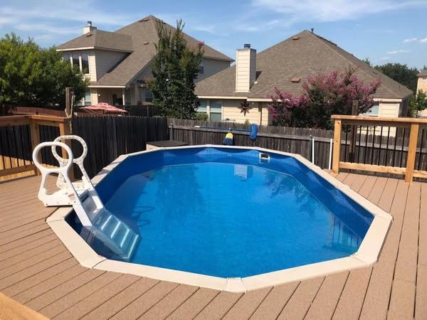 An octagonal swimming pool with a ladder attached to it