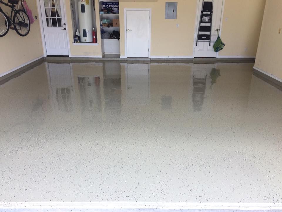 A garage with a shiny floor and a ladder.