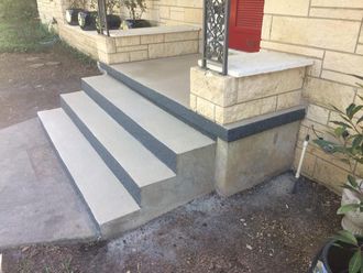 A set of concrete steps leading up to a brick building.