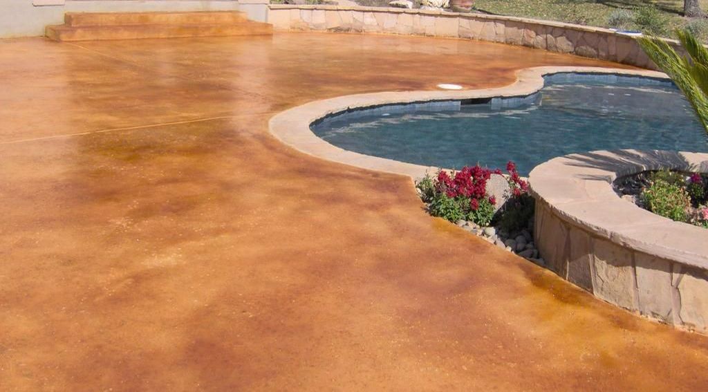 A hallway with cubicles and a blue carpet