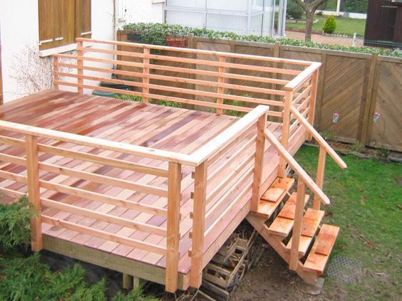 A wooden deck with stairs leading up to it