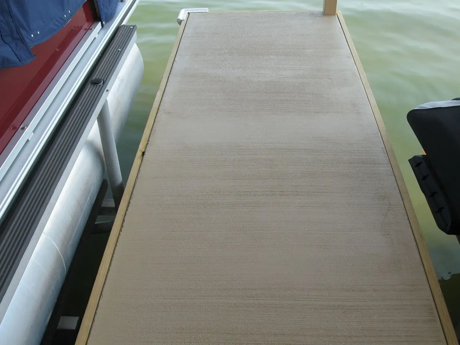 A boat is docked at a dock in the water