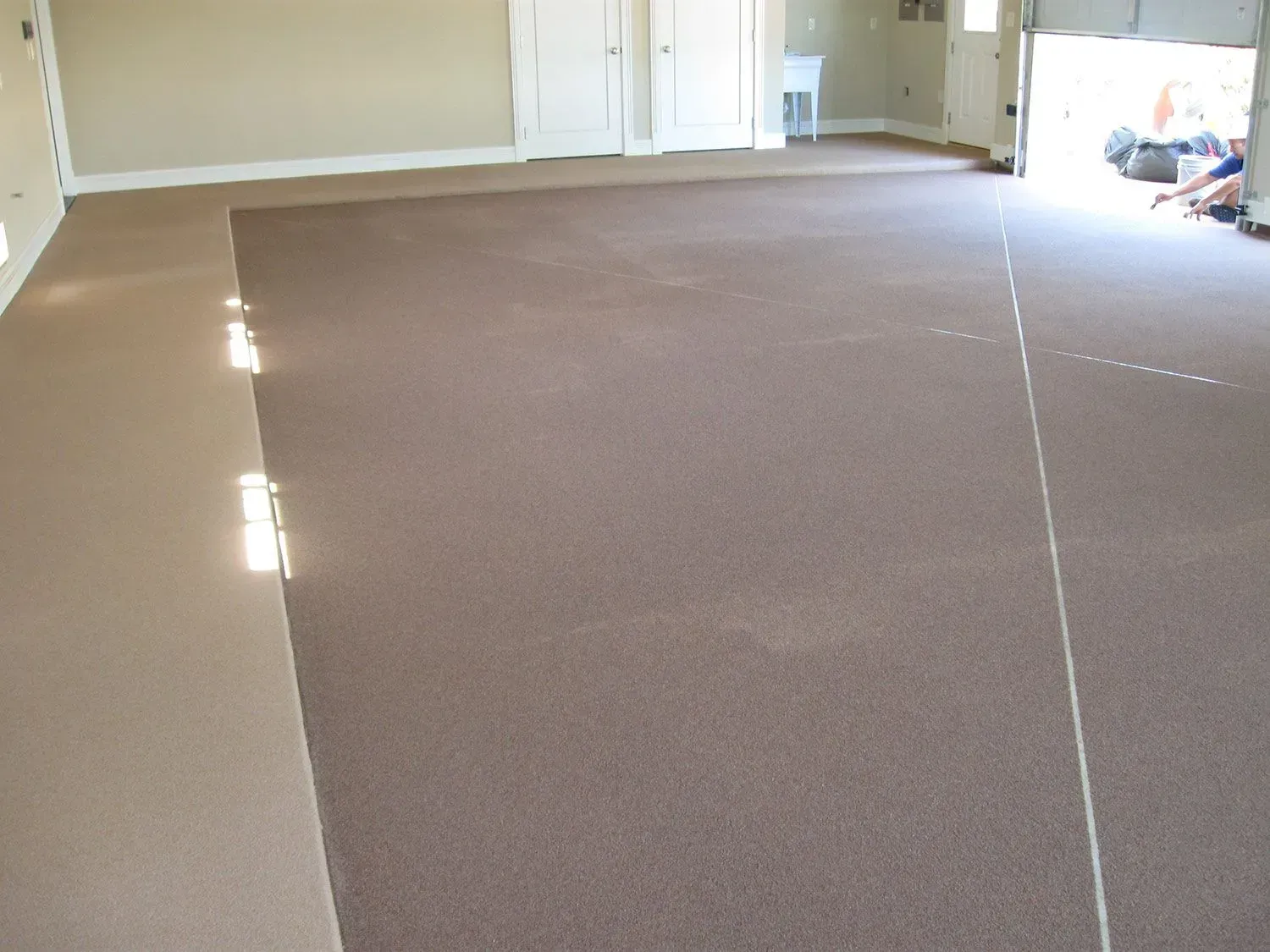 A large room with a brown carpeted floor