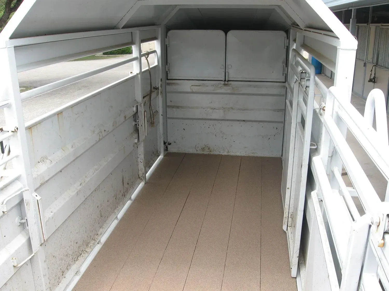 The inside of a white trailer with a roof