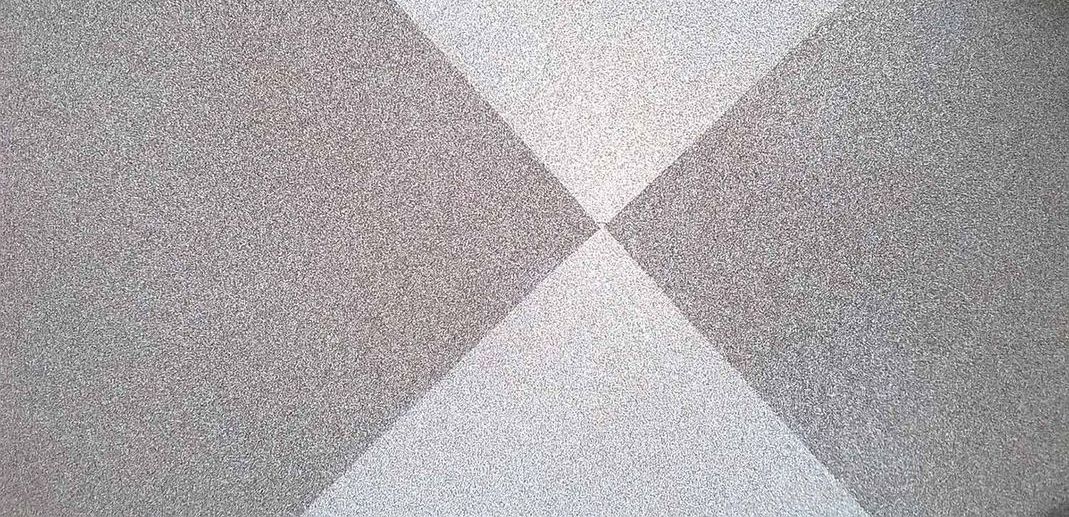 A close up of a carpet with a checkered pattern on it.