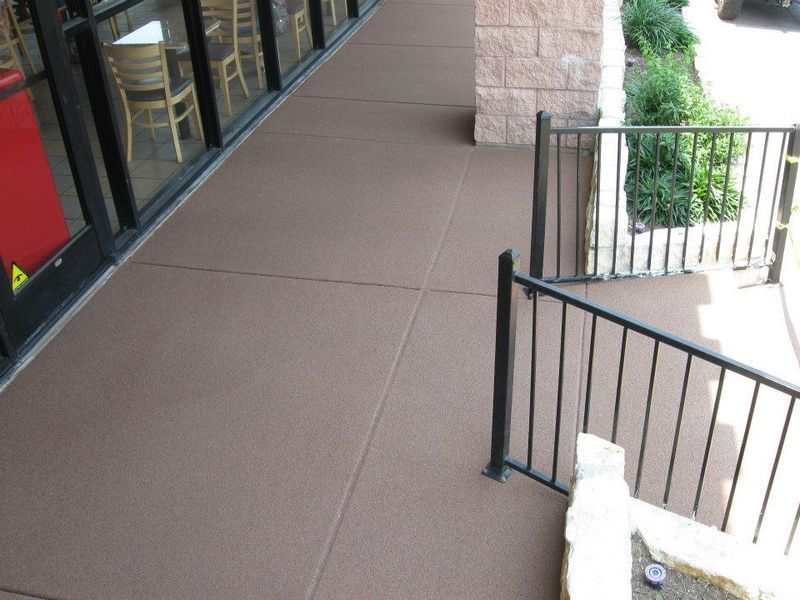 Stairs leading up to a building with tables and chairs