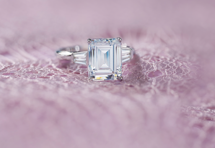 Diamond engagement ring with an emerald-cut center stone 