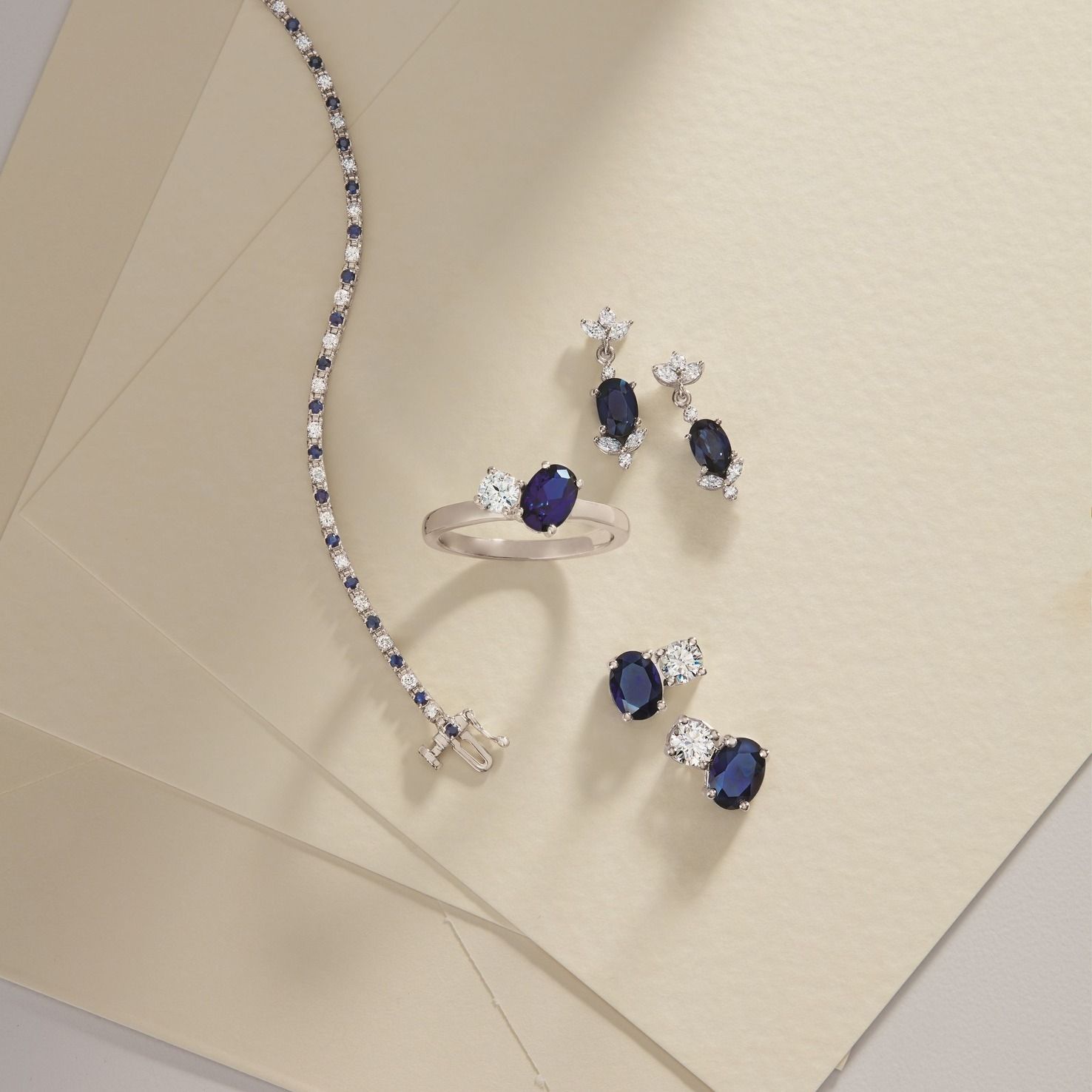 sapphire ring, bracelet, and earrings with white diamond accents 