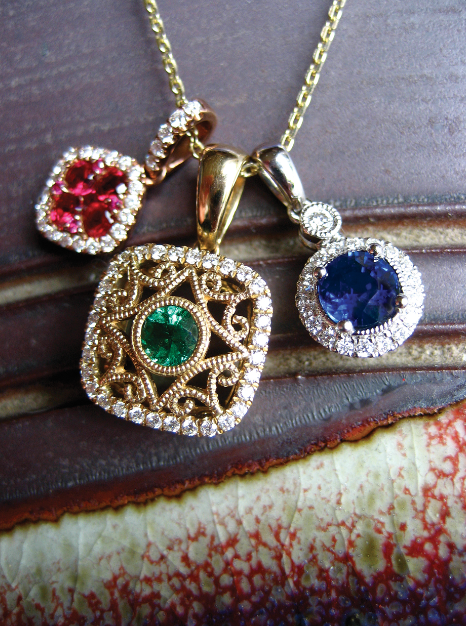 Three gemstone pendants on gold chains