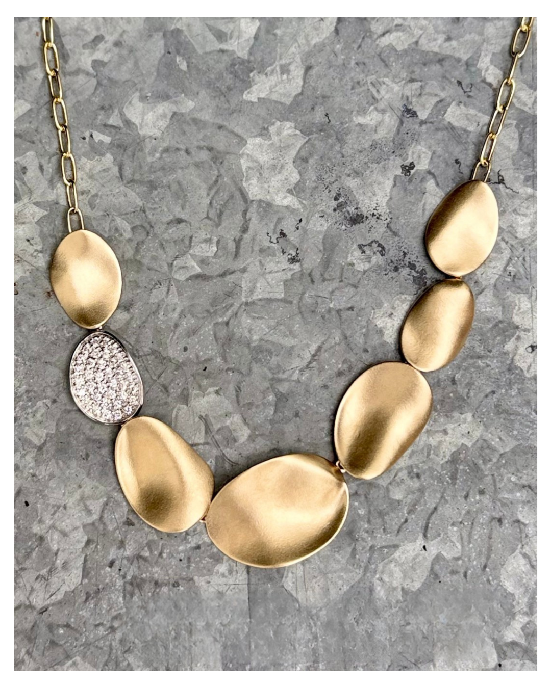 Gold-tone necklace with large pebble-shaped pendants