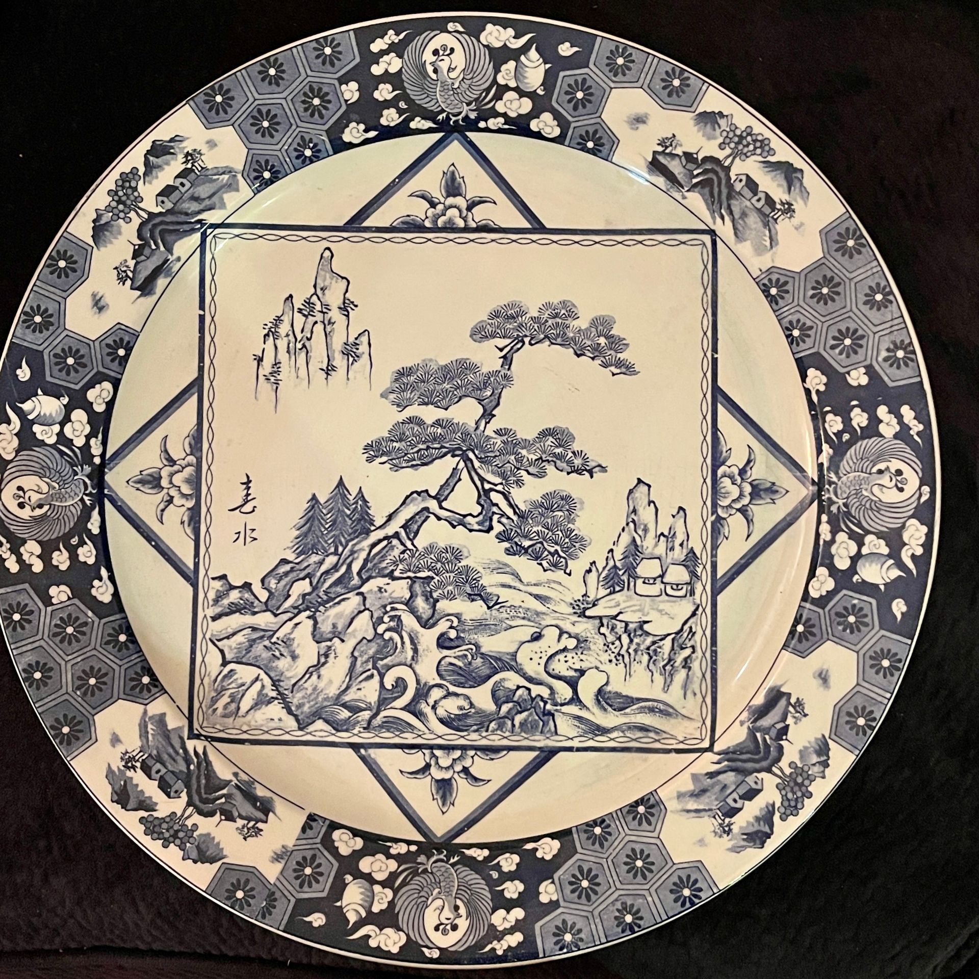 Blue and white porcelain plate set with detailed border patterns.