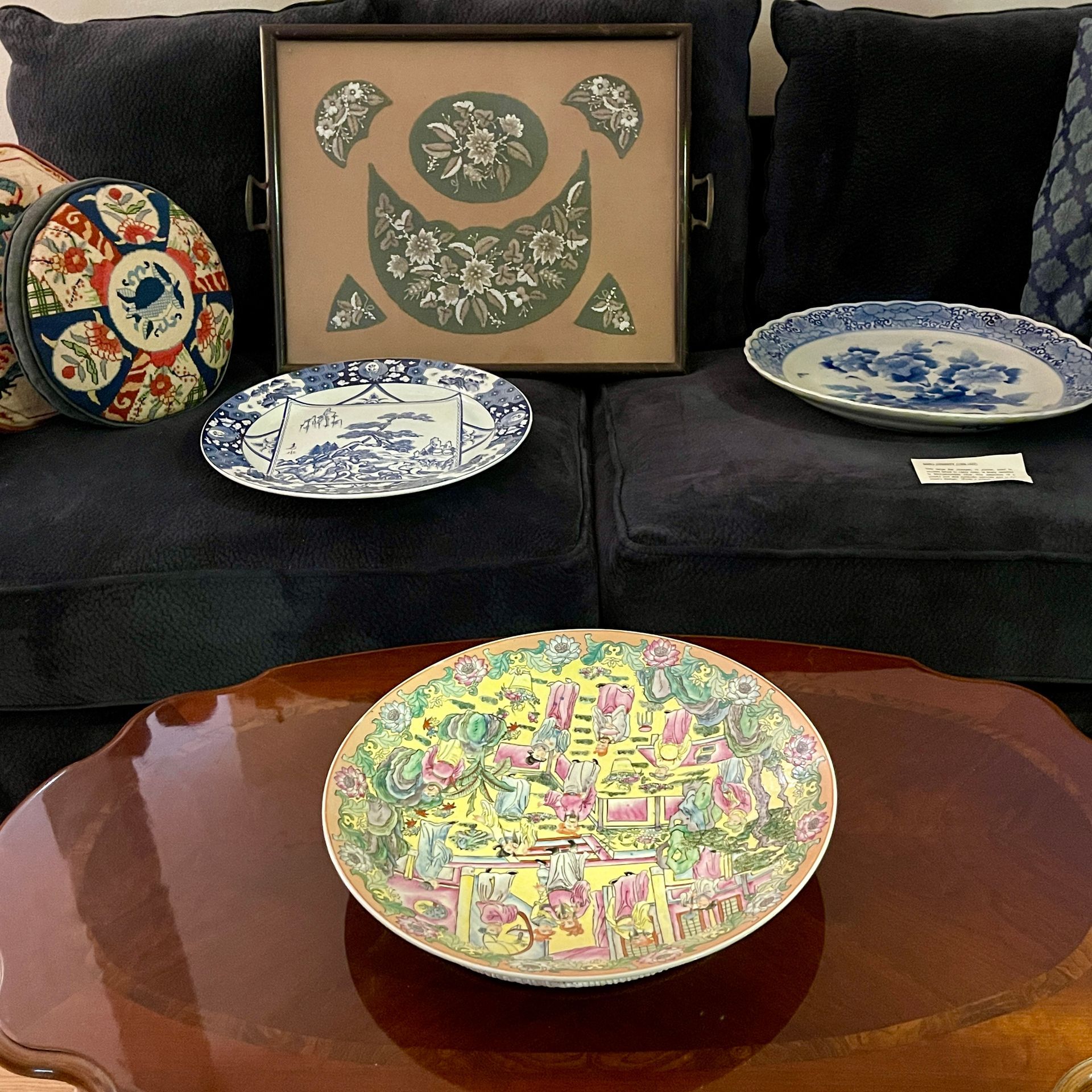 Collection of decorative plates. Includes floral and scenic designs, colorful and blue/white patterns.