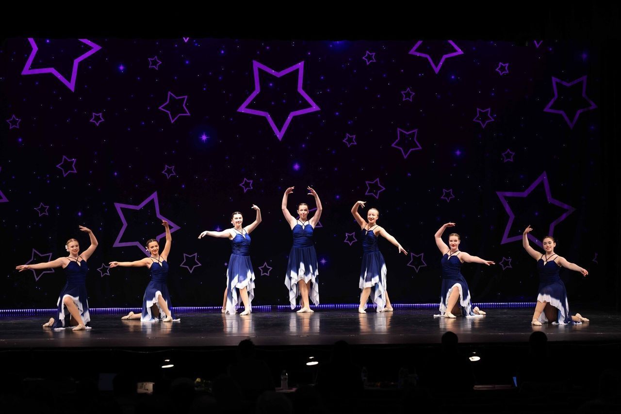 A group of young women are dancing on a stage.