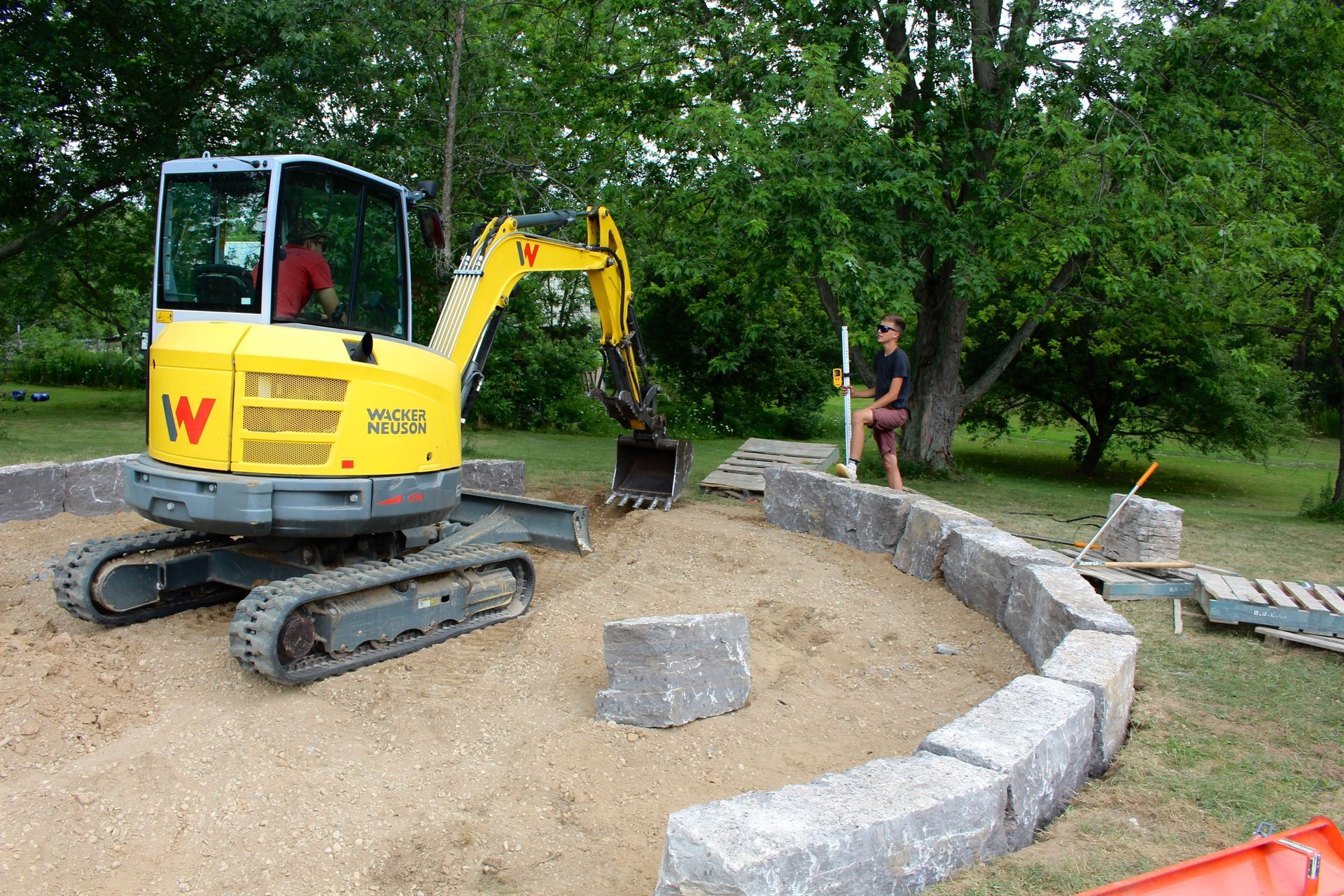 A yellow excavator with the letter w on the front