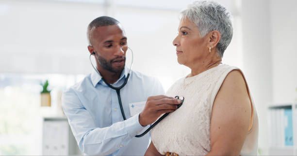 woman with dementia having her vital signs taken by medical professional