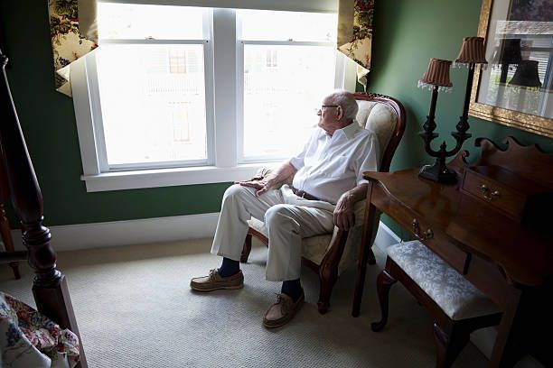 Elderly man sitting alone in isolation. Loneliness can be a contributing factor to dementia