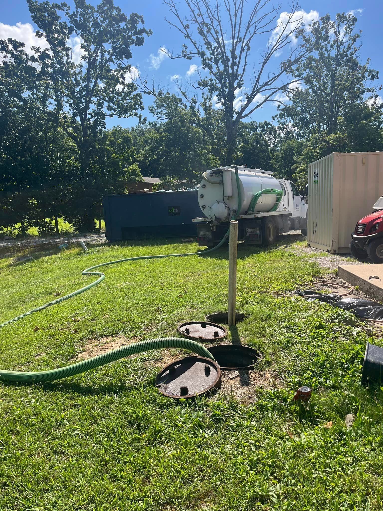 Septic truck parked in yard, pumping septic tank | Houston MO 