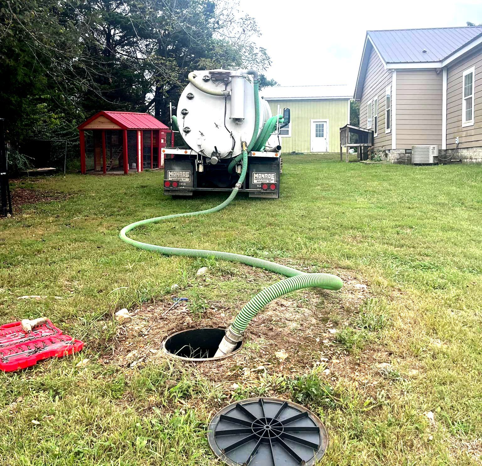 Septic truck pumping septic tank at residential property near Ft. Leonard Wood, MO