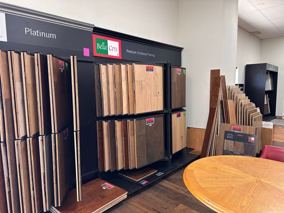 Display of various wood flooring samples in a showroom setting.