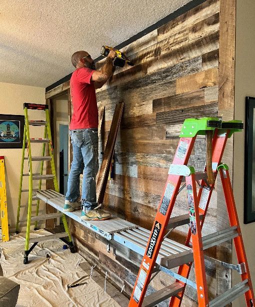 man drilling on the wall