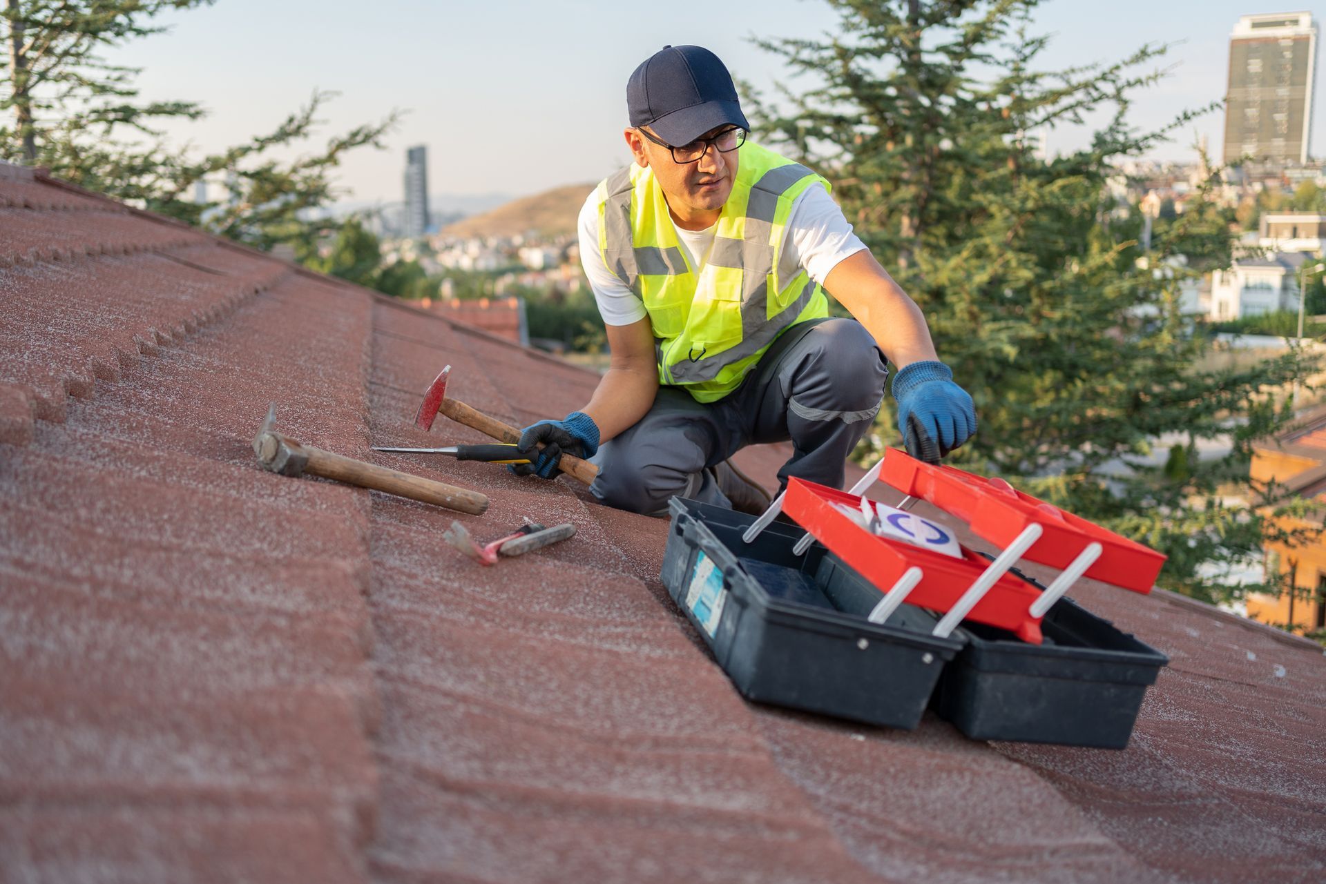 Image of a roofing contractor replacing tiles on an old roof.