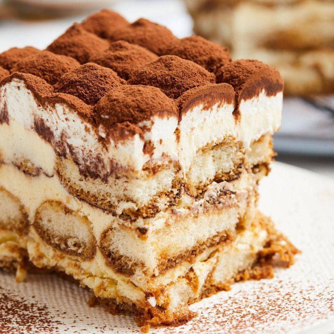 a close up of a tiramisu cake on a white plate