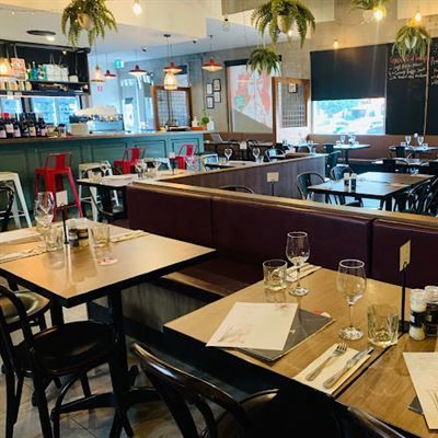 Italian restaurant with tables and chairs set up for a meal .