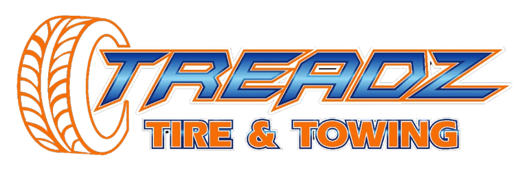 A logo for treadz tire and towing with a tire on it