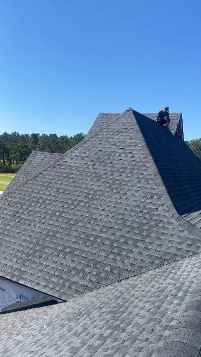 Man Standing On Top Of A Large Roof — Enterprise, AL — Waters Roofing LLC
