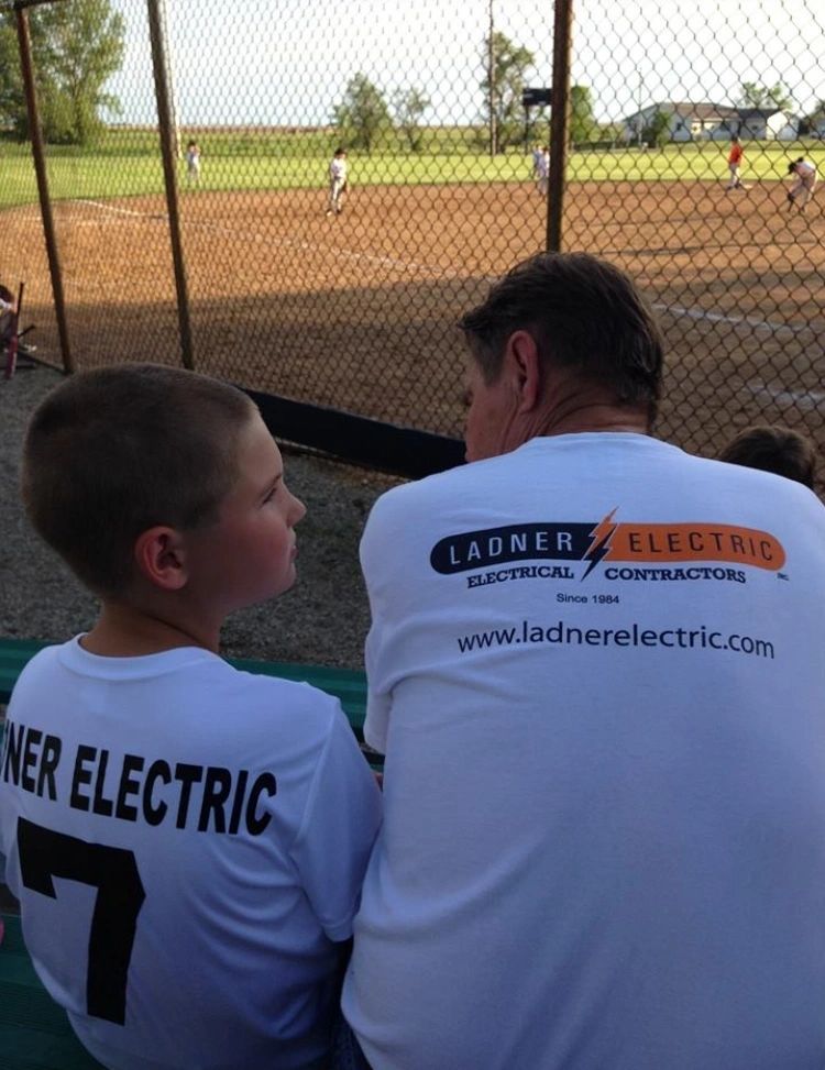 A Boy and a Man Wearing a Launer Electric Shirt - Aberdeen, SD - Ladner Electric