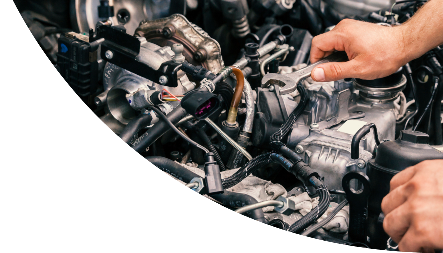 A person is working on a car engine with a wrench | TN3 Automotive