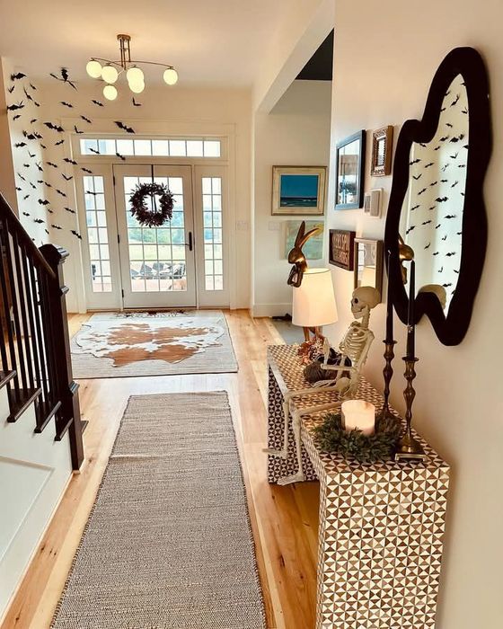 A living room with a couch and a kitchen with hardwood floors.