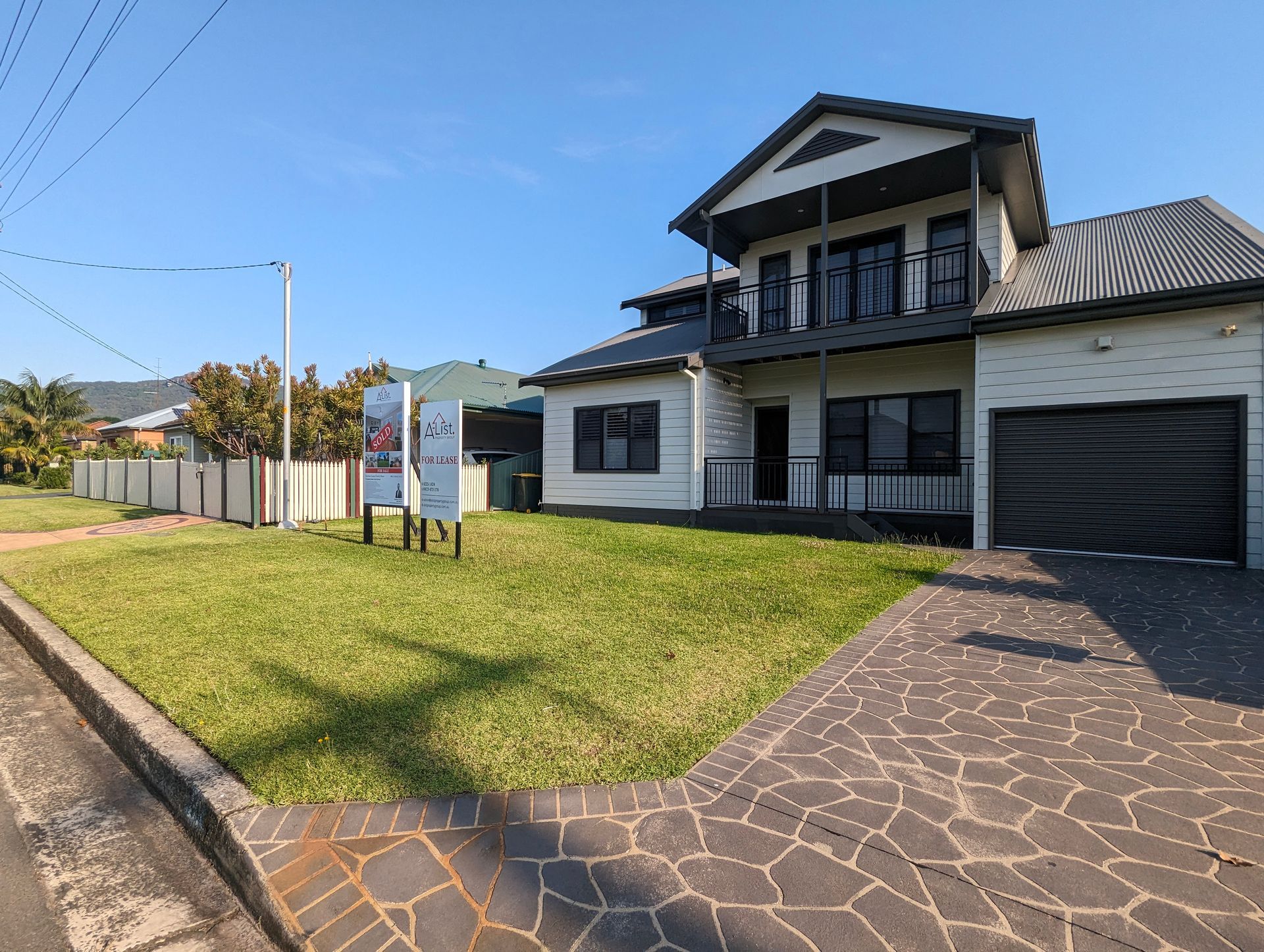 A Lush Green Garden With Trees And Bushes And A Path — Roots, Shoots & Leaves Garden Maintenance In East Corrimal, NSW
