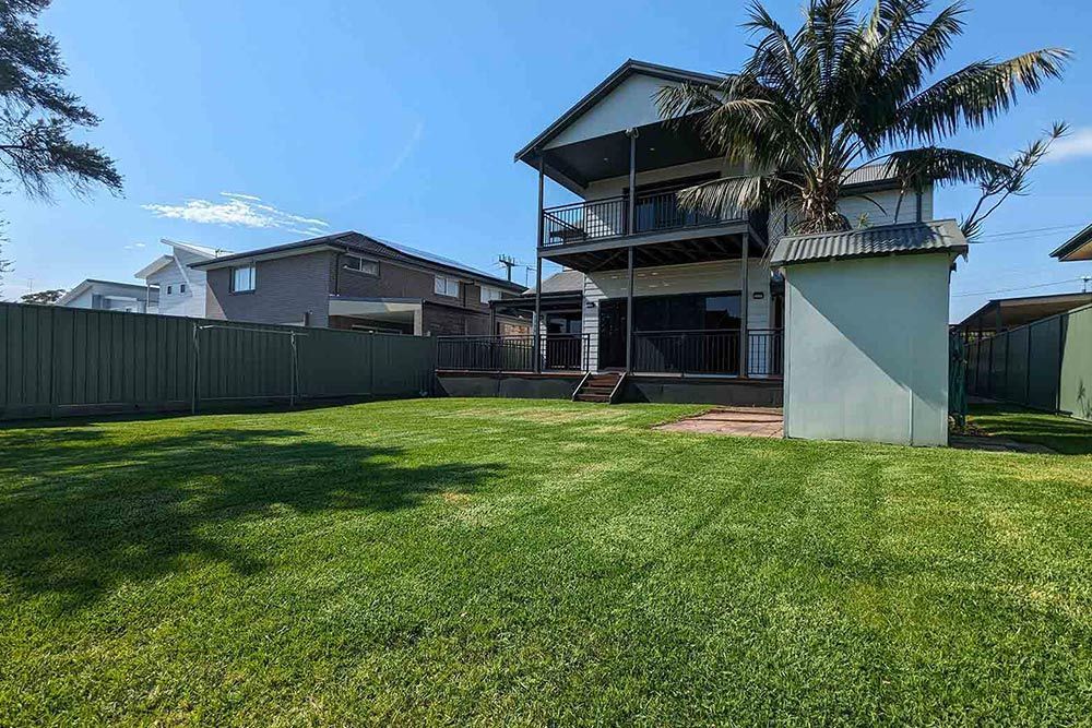 A Close Up Of A White Flower Surrounded By Green Leaves — Roots, Shoots & Leaves Garden Maintenance In East Corrimal, NSW