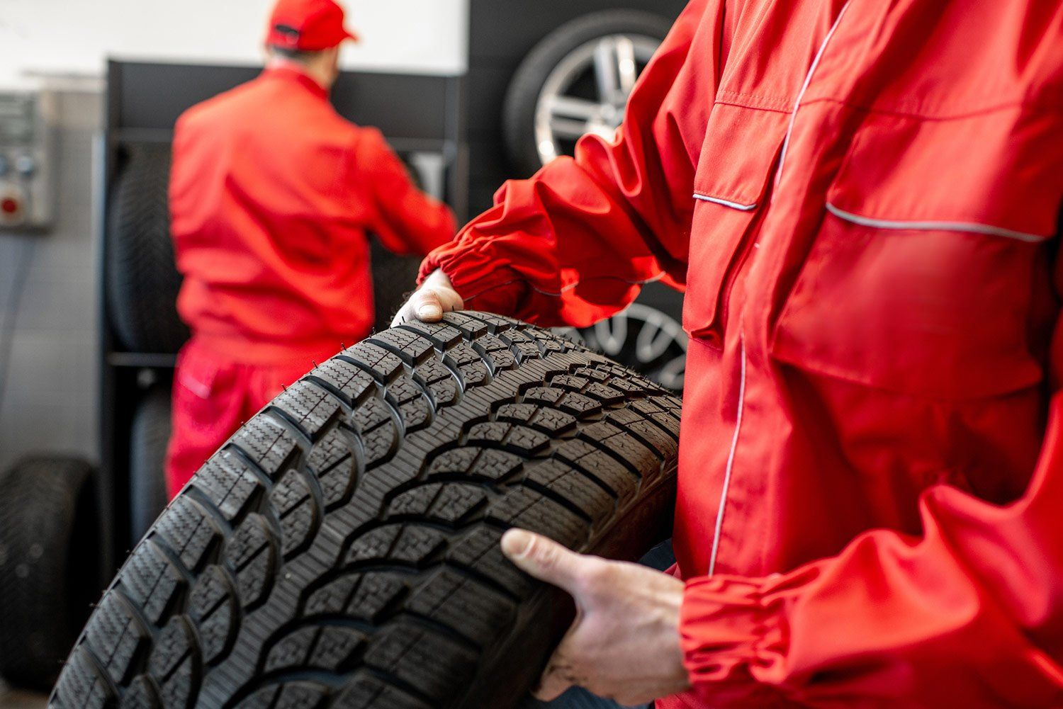 Mechanic Holding Car Tire — Branson, MO — Crawford's Automotive & Towing