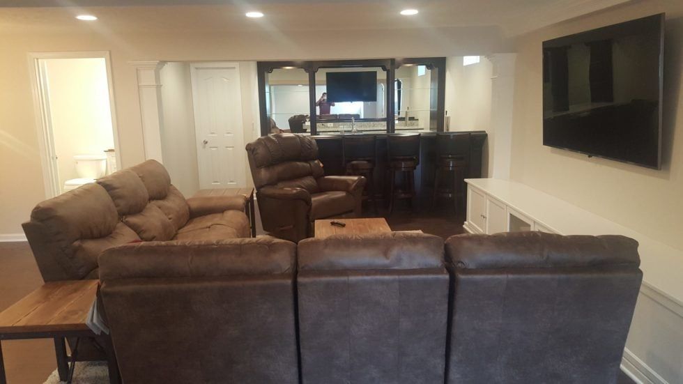 A living room filled with furniture and a flat-screen TV.